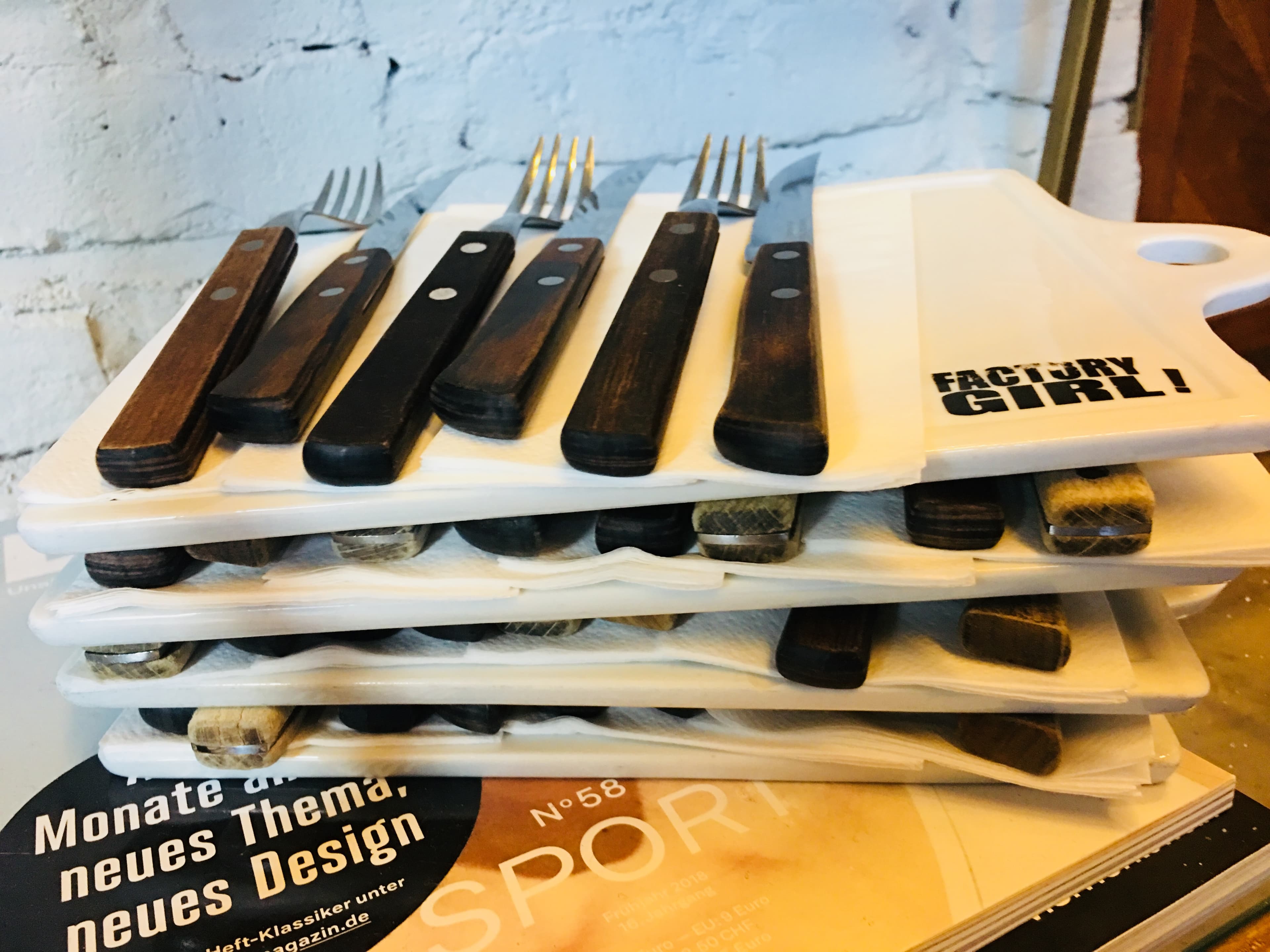 Factory Girl Friedrichstrasse event setup with branded boards and cutlery