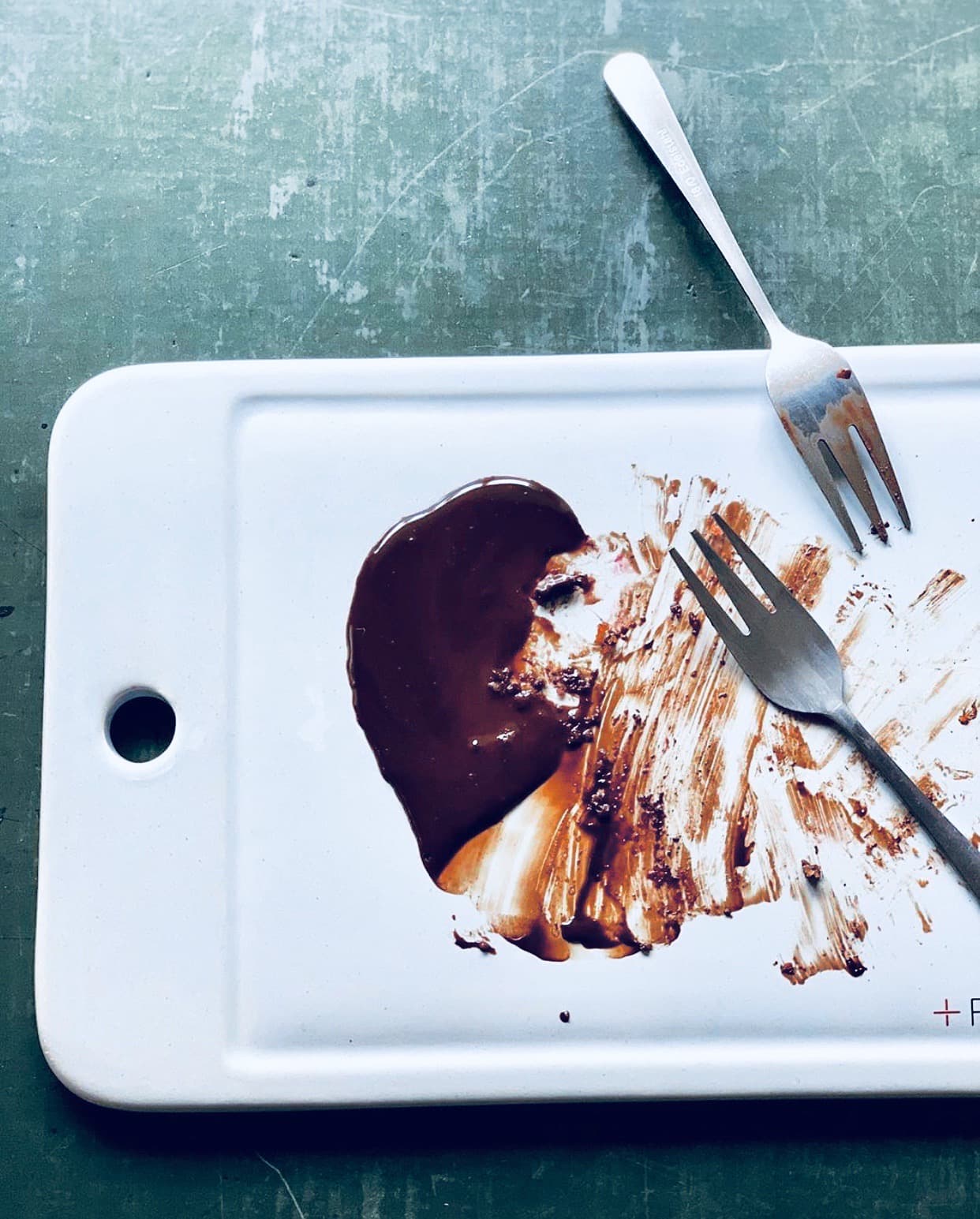 Factory Girl Rykestraße events hero with chocolate dessert board and two forks on a green surface