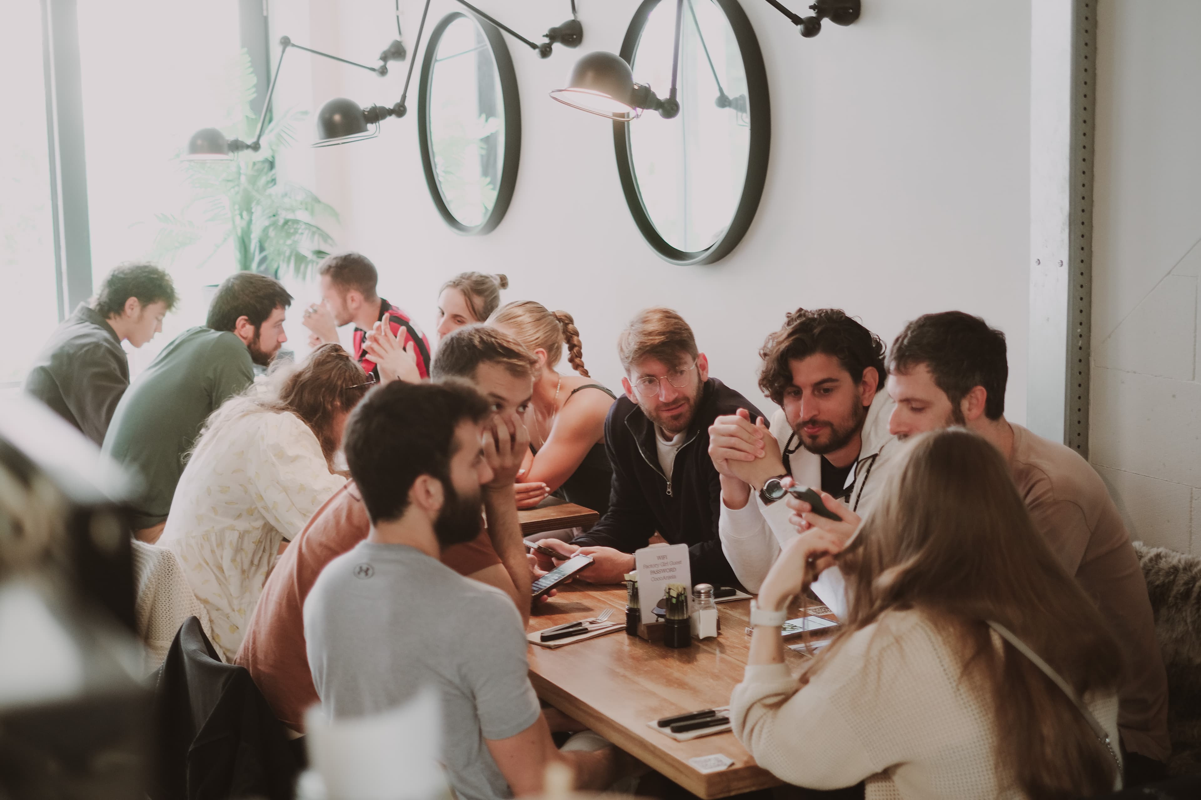Long-table gathering with guests talking over brunch at Factory Girl